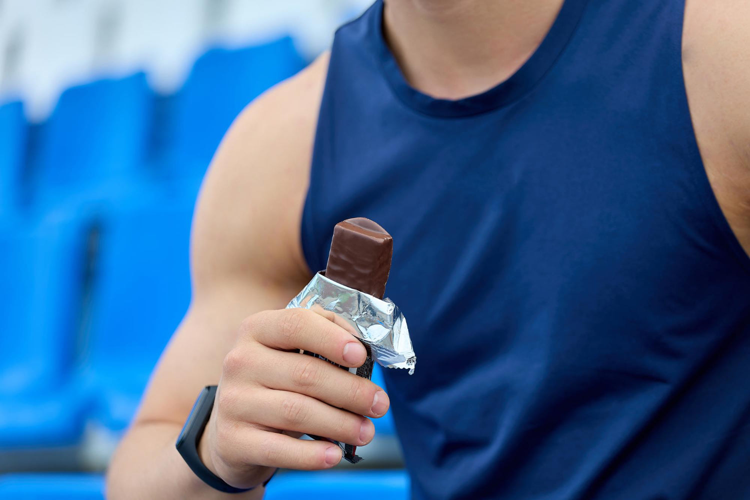 man eating a creatine bar